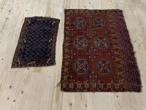 A Caucasian rug, the centre panel with lattice, diamond and flowerhead alternating design, some patches of repair and wear, enclosed within multiple flowerhead and leaf border, dark blue field (270cm x 158cm), £120-180